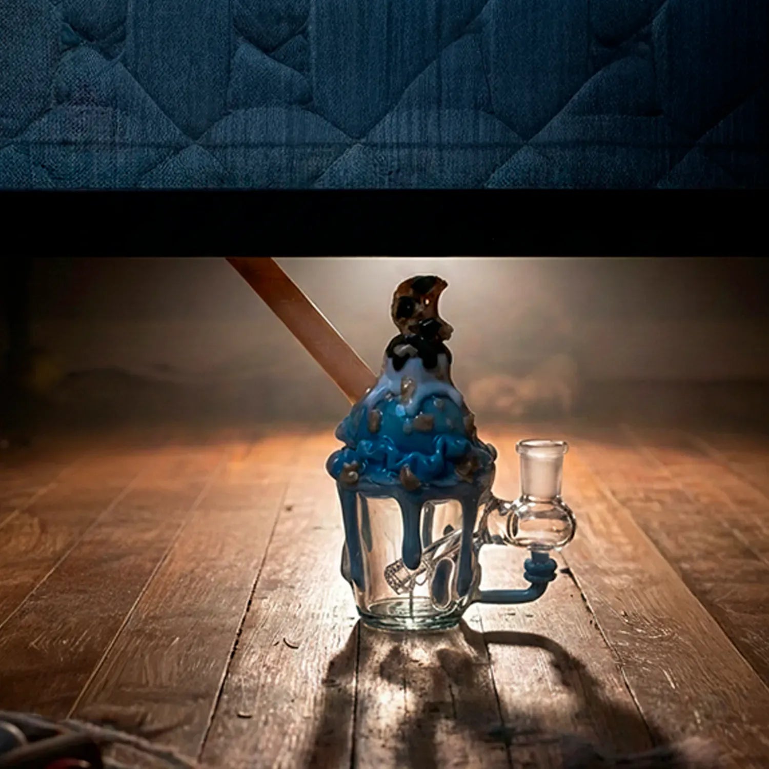 Centered low-angle shot of the Cookie Monster Sundae Nano Rig on a wooden floor, warm backlight casting a long shadow.