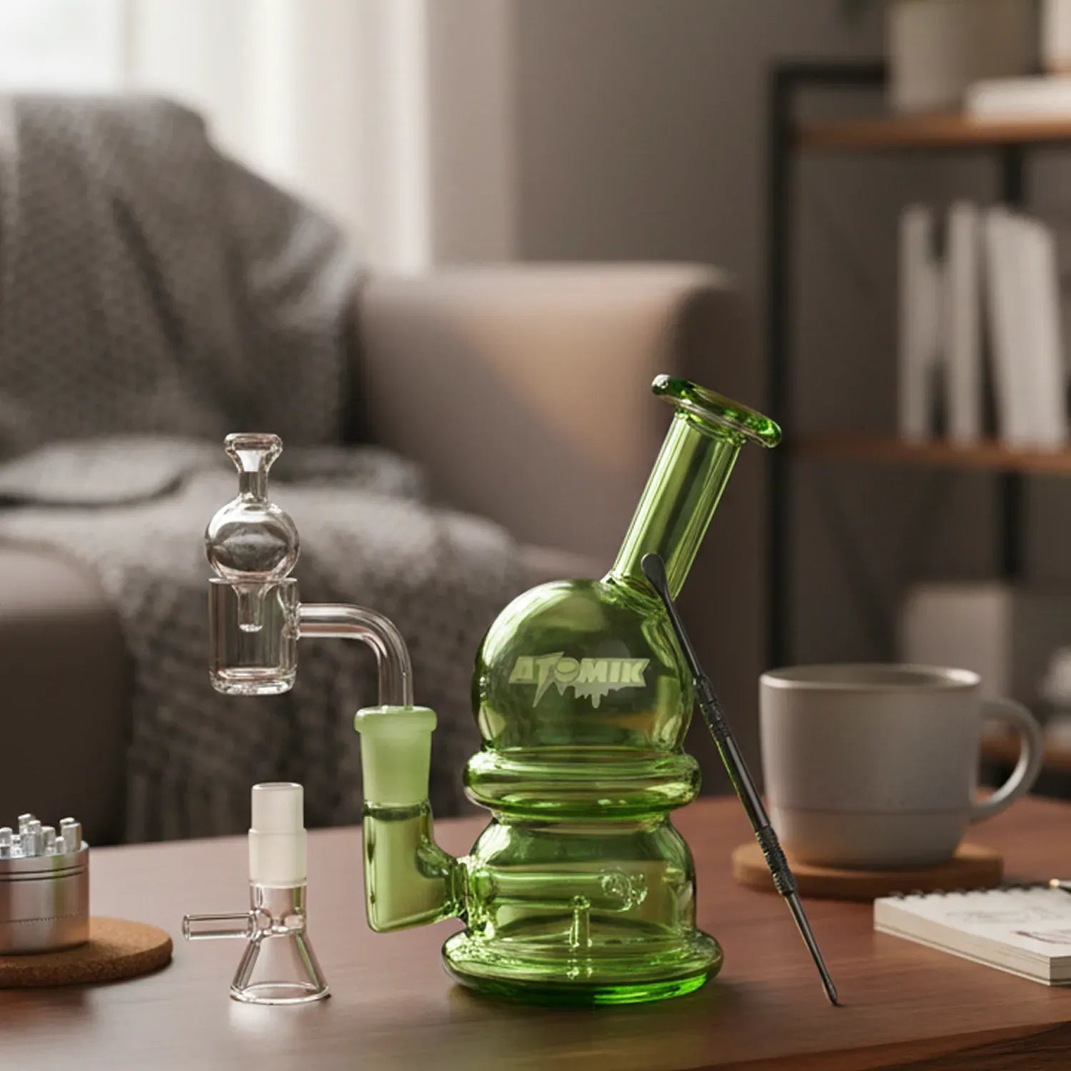 Three-quarter view of the green 5.5in Atomik - Special Edition Water Pipe sitting on a wooden table with accessories and a mug in soft background light