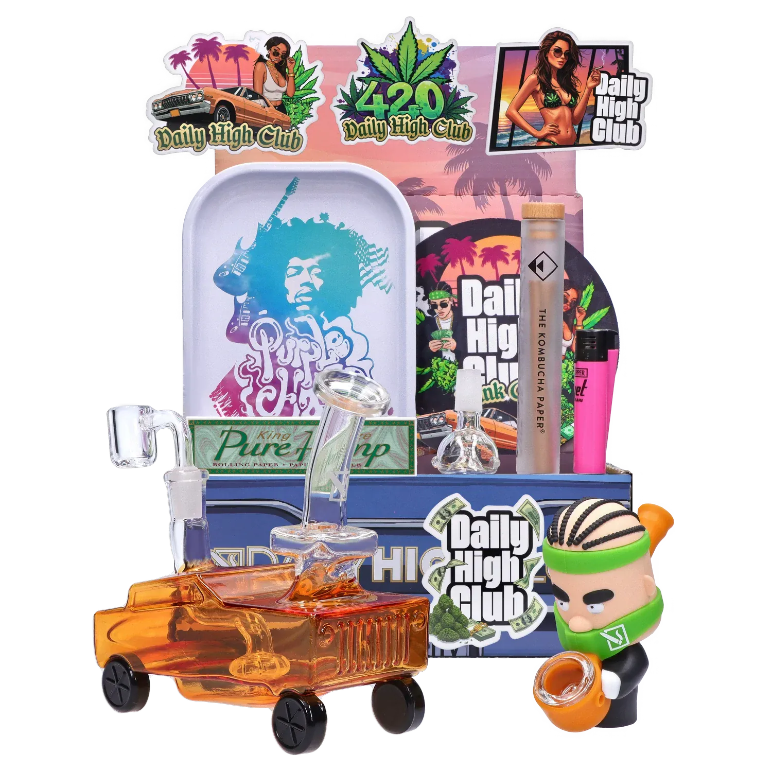 Front-facing arrangement of the "Dank City" Smoking Box showing colorful stickers, a purple-graphic tray, glass rig pieces, a small orange car-shaped glass piece, and a cartoon figurine.