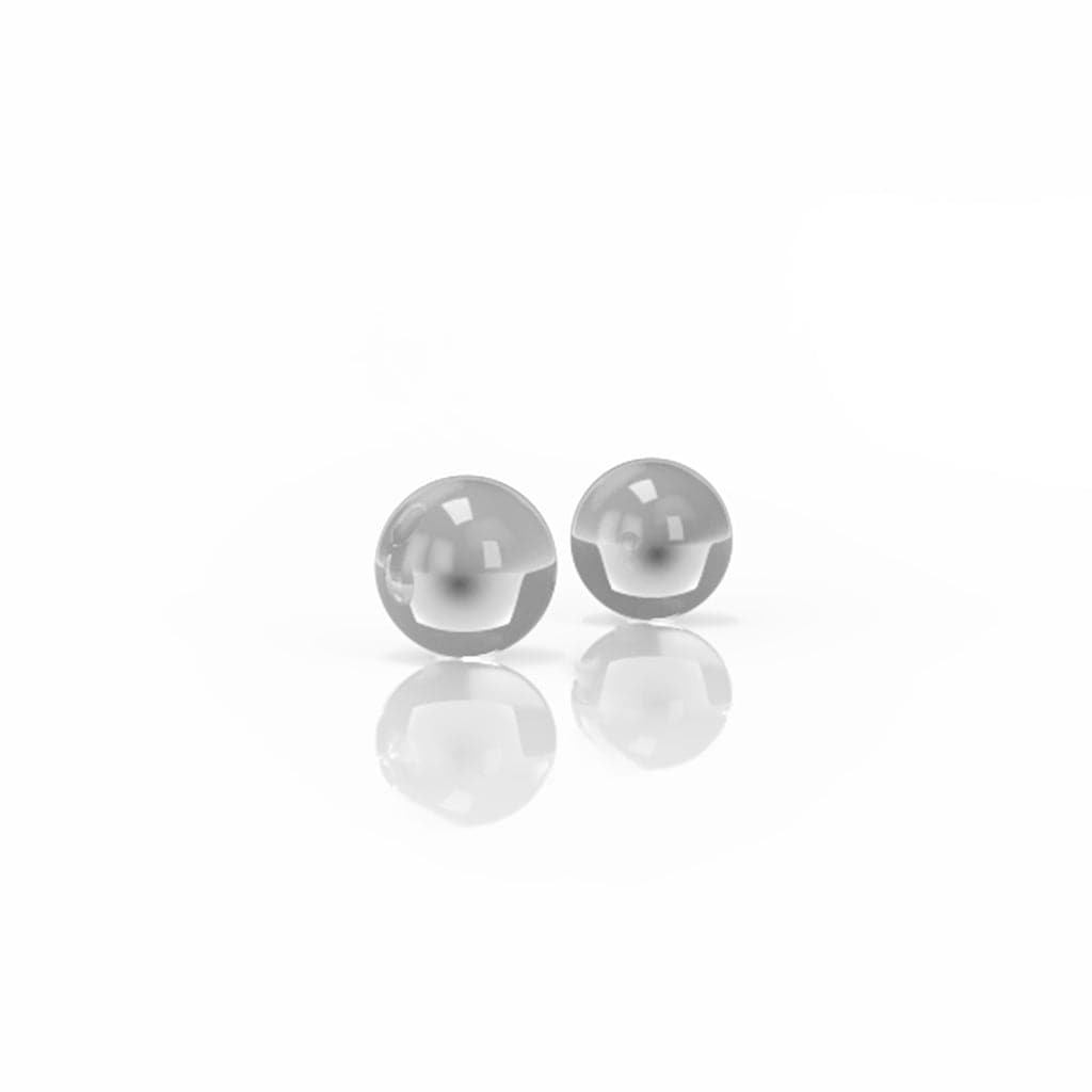 Close-up, front view of two clear 6mm Honey Terp Pearls resting on a reflective white surface with soft overhead highlights.