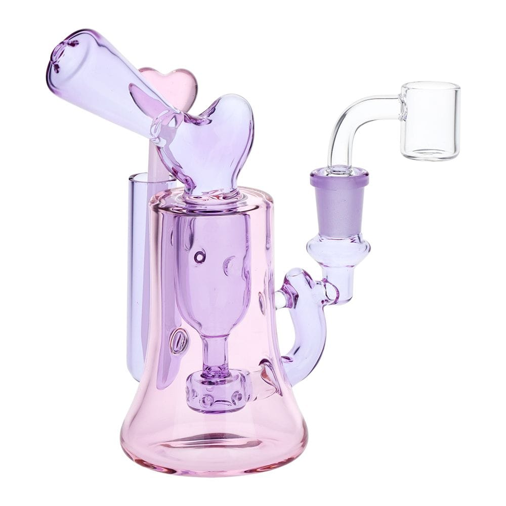 Front three-quarter view of the Lovely Heart Glass Dab Rig Set - 6.25" / 14Mm F, showing its translucent pink-purple heart-shaped mouthpiece and curved clear quartz banger against a white background