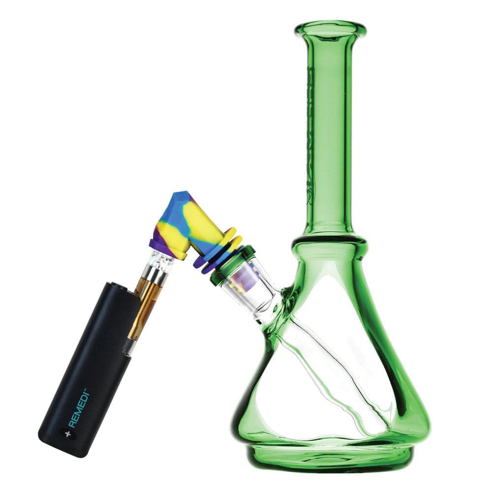 Three-quarter view of a green glass water pipe fitted with a colorful blue-yellow-purple Pulsar Silicone Cart Rig Adapter angled toward a black vape battery.