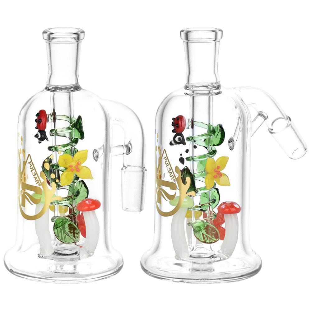 45-degree angled view of the Pulsar Trippy Garden Ash Catcher | 14Mm showing two clear glass pieces with internal green spiral, yellow flower, and red mushroom accents.