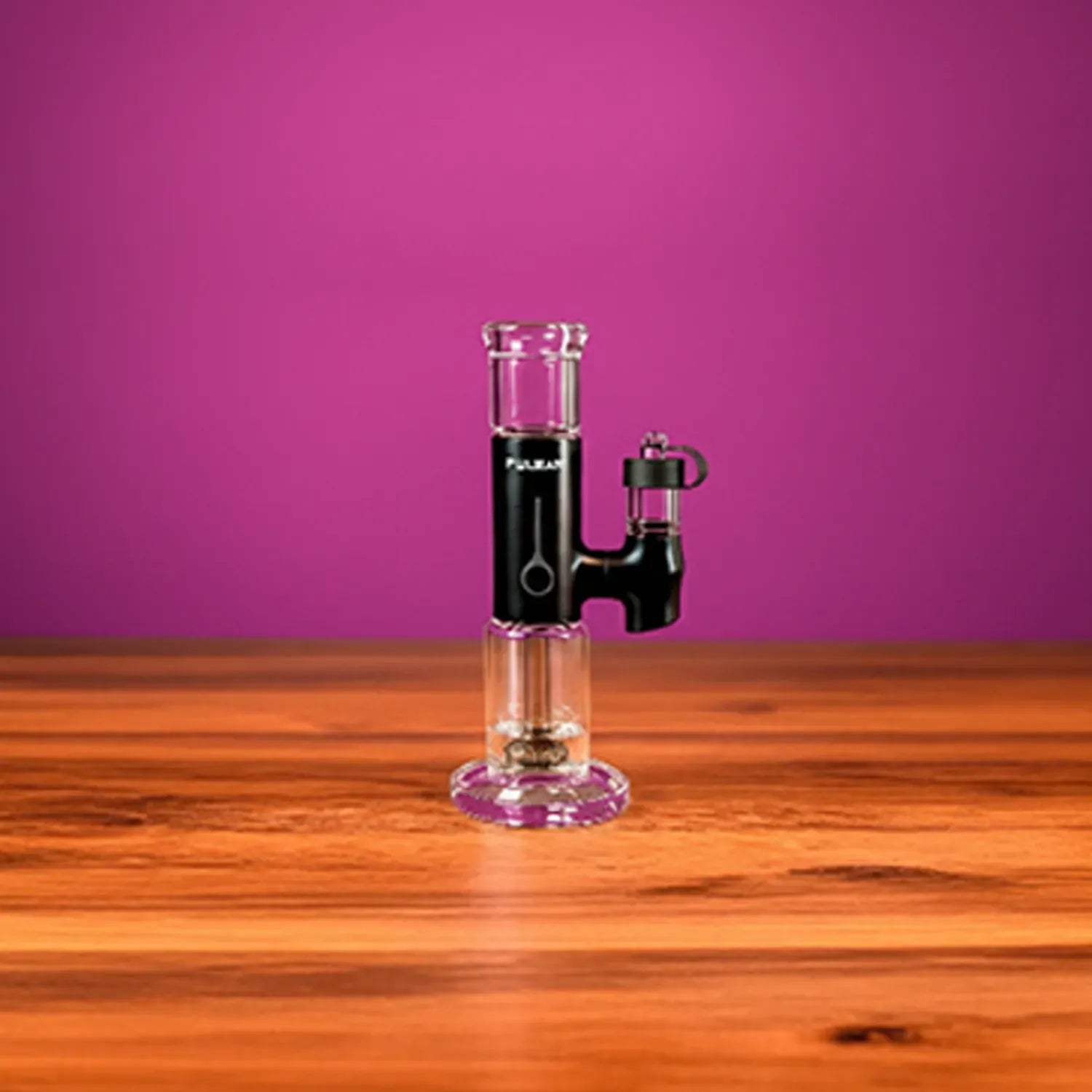 Center-frontal view of the Pulsar Apx Erig | 3200Mah standing on a wooden table against a magenta backdrop.