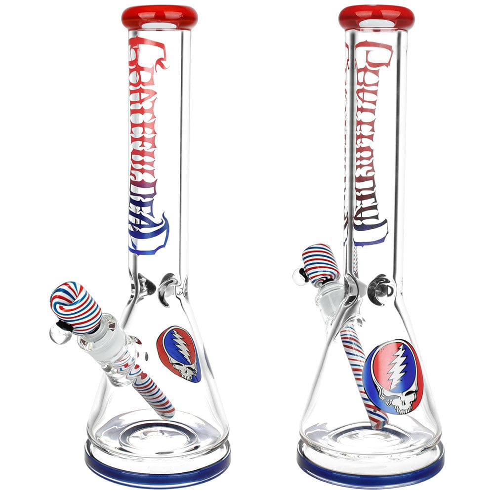 Front-facing shot of the Grateful Dead X Pulsar "Liberty Beaker" Bong - 15.75" / 14Mm F showing two identical clear glass beakers with red-rimmed mouths, blue-striped downstems and Grateful Dead skull decals.