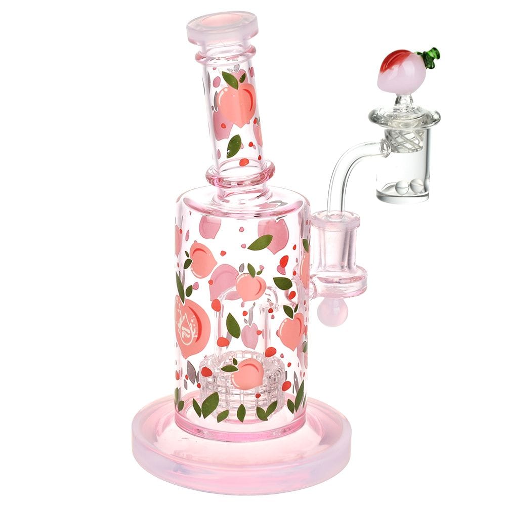 Angled front view of the Pulsar Fruit Series Peaches & Cream Glow In The Dark Dab Rig Kit - 8" showing pink glass with peach decals.