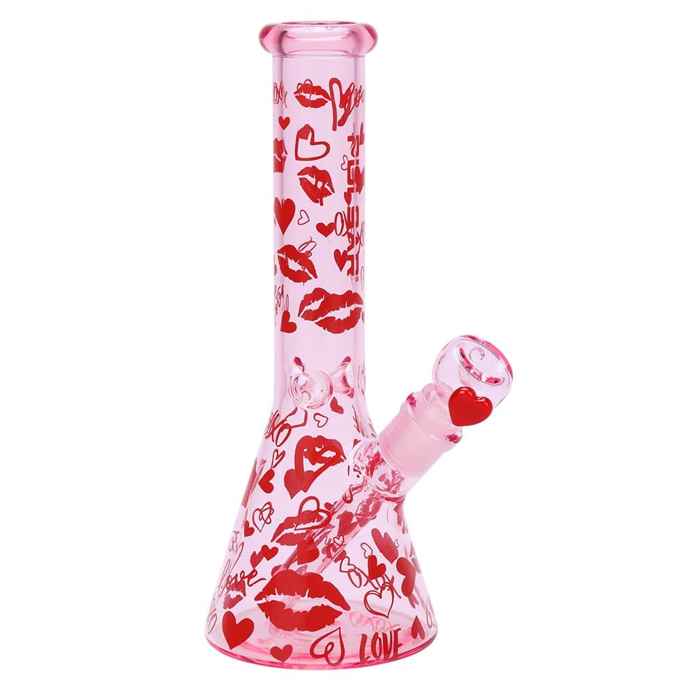 Straight-on view of the pink Pulsar Valentine'S Xoxo Glass Beaker Water Pipe & Hand Pipe Set - 10" / 14Mm F, decorated with red lips and hearts.