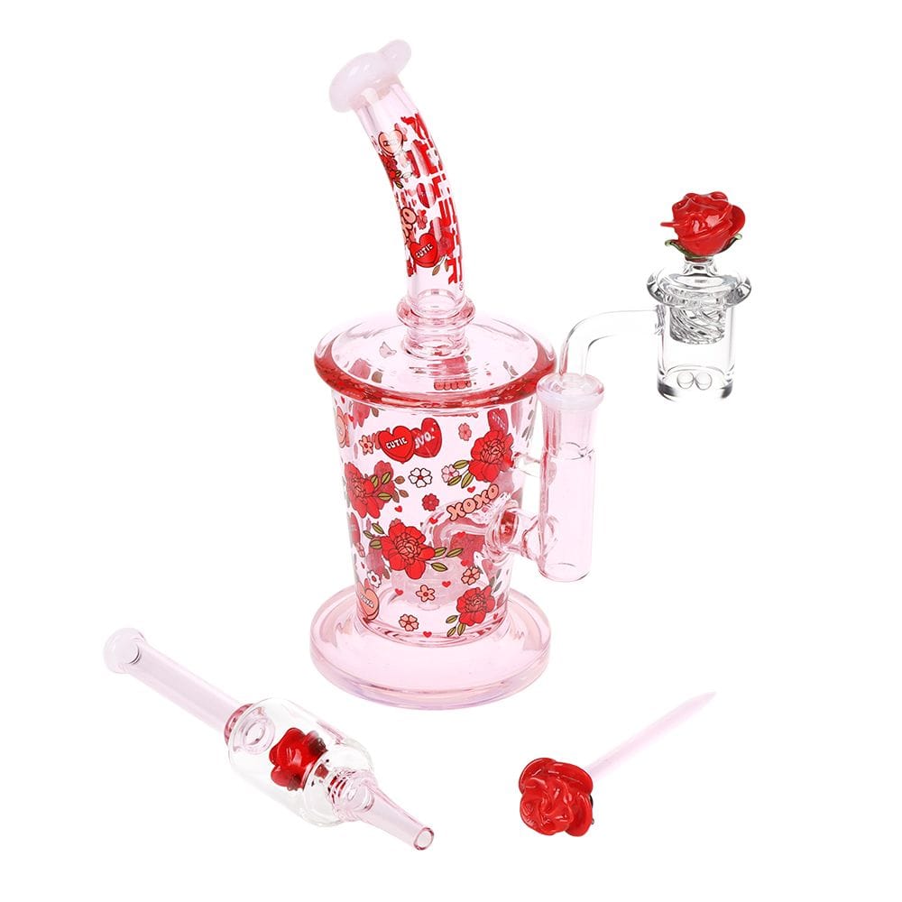 Angled front view of the Pulsar Valentine'S Rose Glass Dab Rig Set - 8.25" / 14Mm F showing a pink, rose-patterned rig and rose-topped accessories.