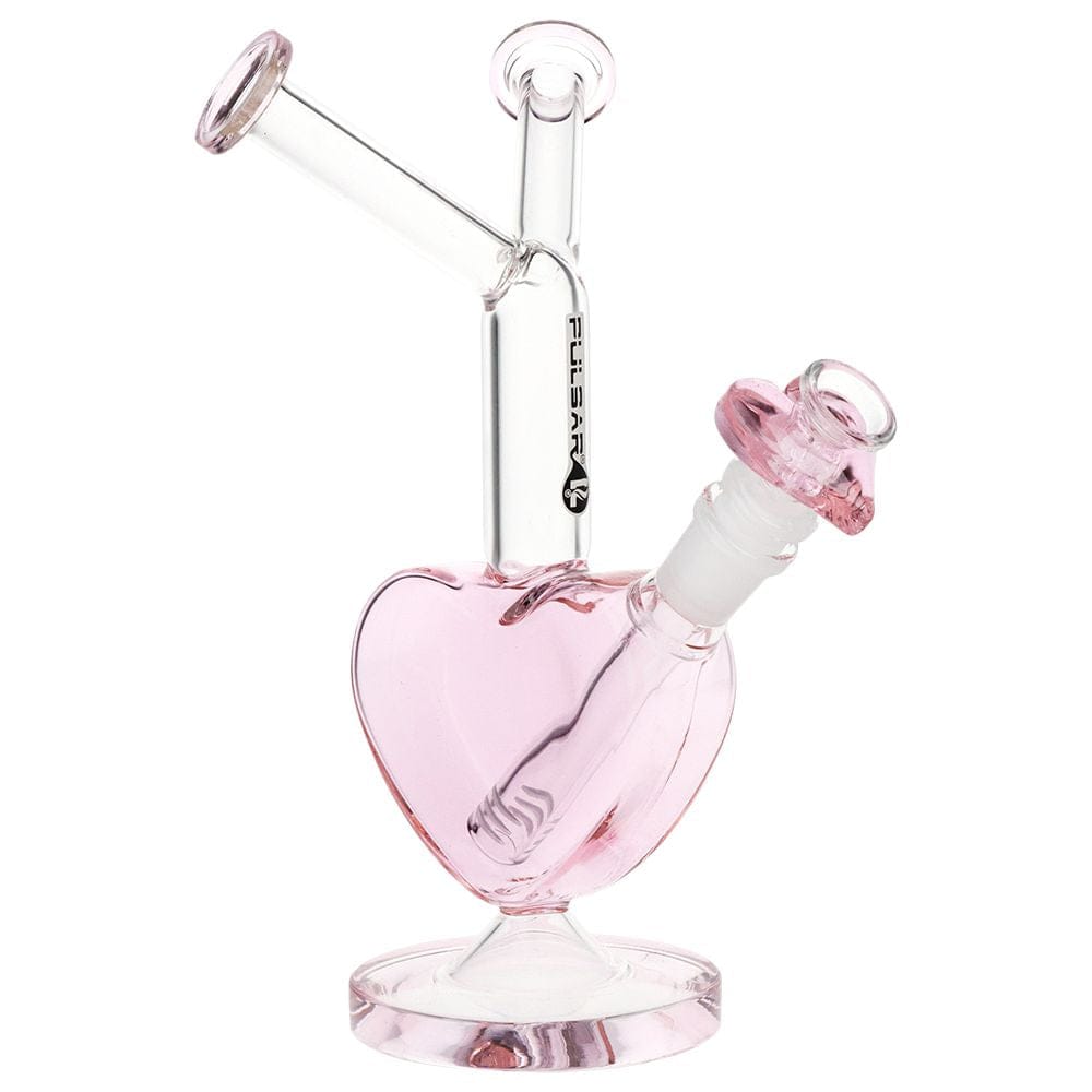 Angled front view of the Pulsar Double Kiss Heart Glass Water Pipe - 11" / 14Mm F showing a pink heart-shaped base, clear angled neck, and matching pink bowl on a white background