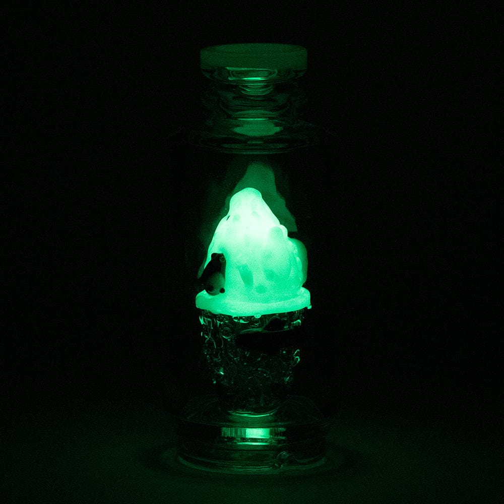 A dramatically lit, front view of the “Avenge the Arctic” Puffco Peak & Peak Pro Glass Attachment, showcasing its unique, icy design.