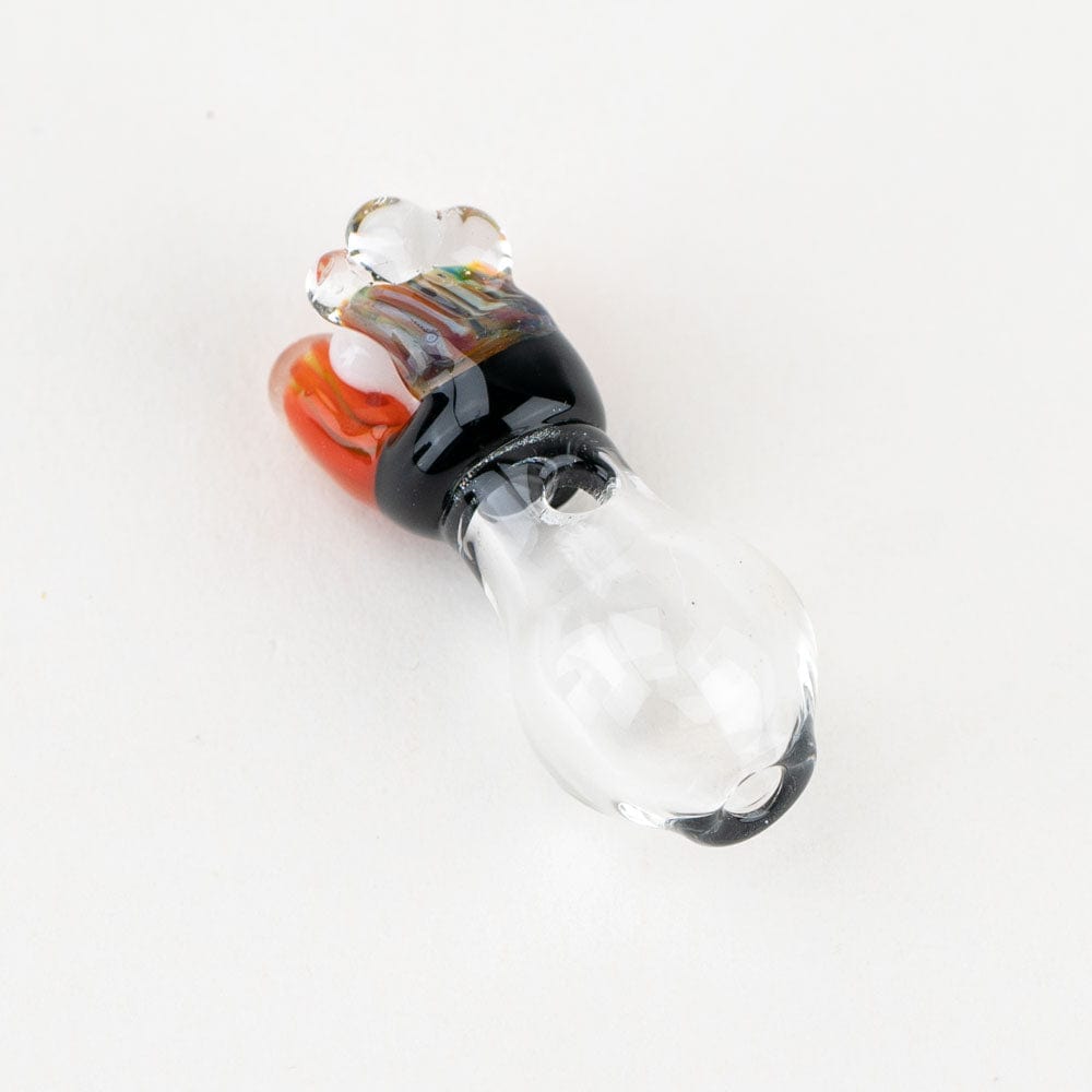 A close-up shot of the Coral PuffCo Peak Pro Glass Ball Cap, showcasing its rounded form and translucent coral-colored glass.