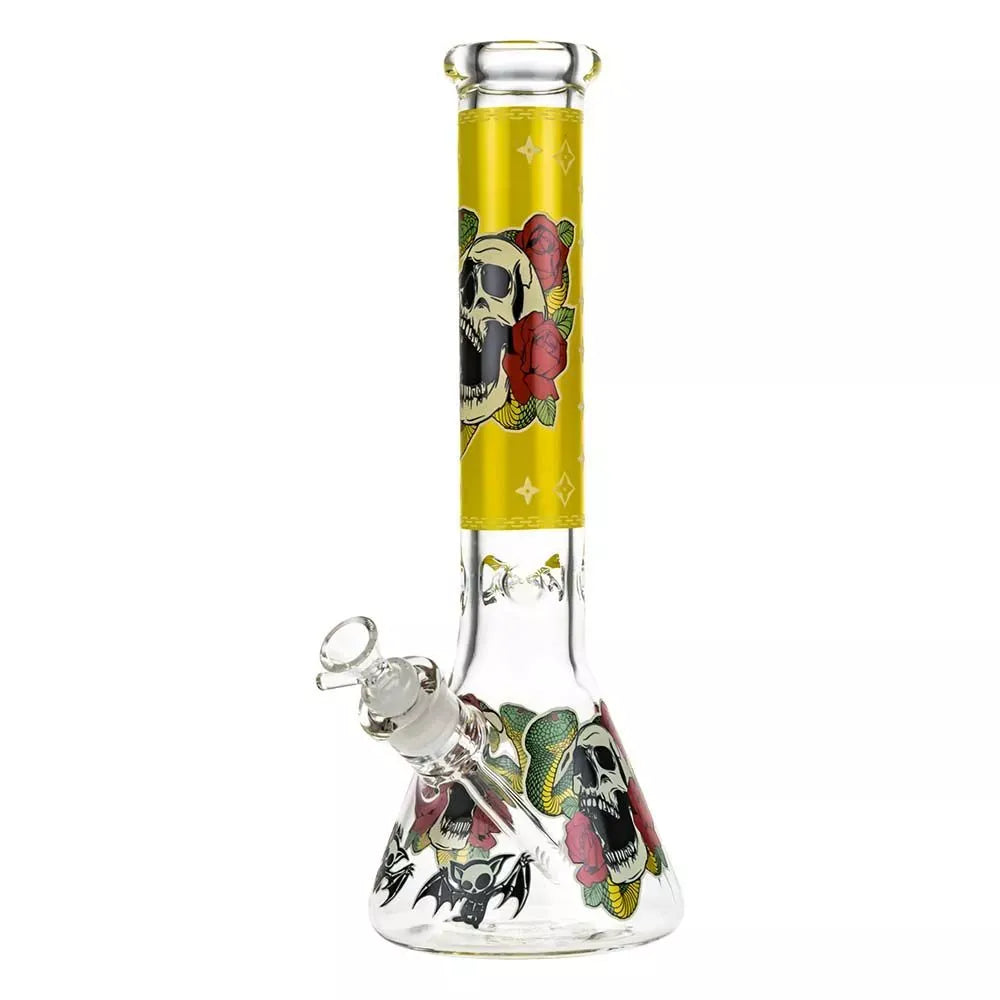 Front-facing view of the Beaker Ice Bong with Glow in the Dark Snake and Skull Print showing a tall yellow-necked beaker with skull, rose and snake artwork wrapping the clear glass base.