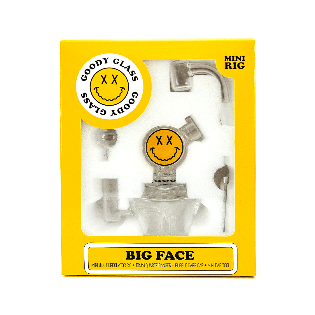Front view of the Big Face Mini Rig 4-Piece Kit, a clear glass rig with a patterned joint and included components.