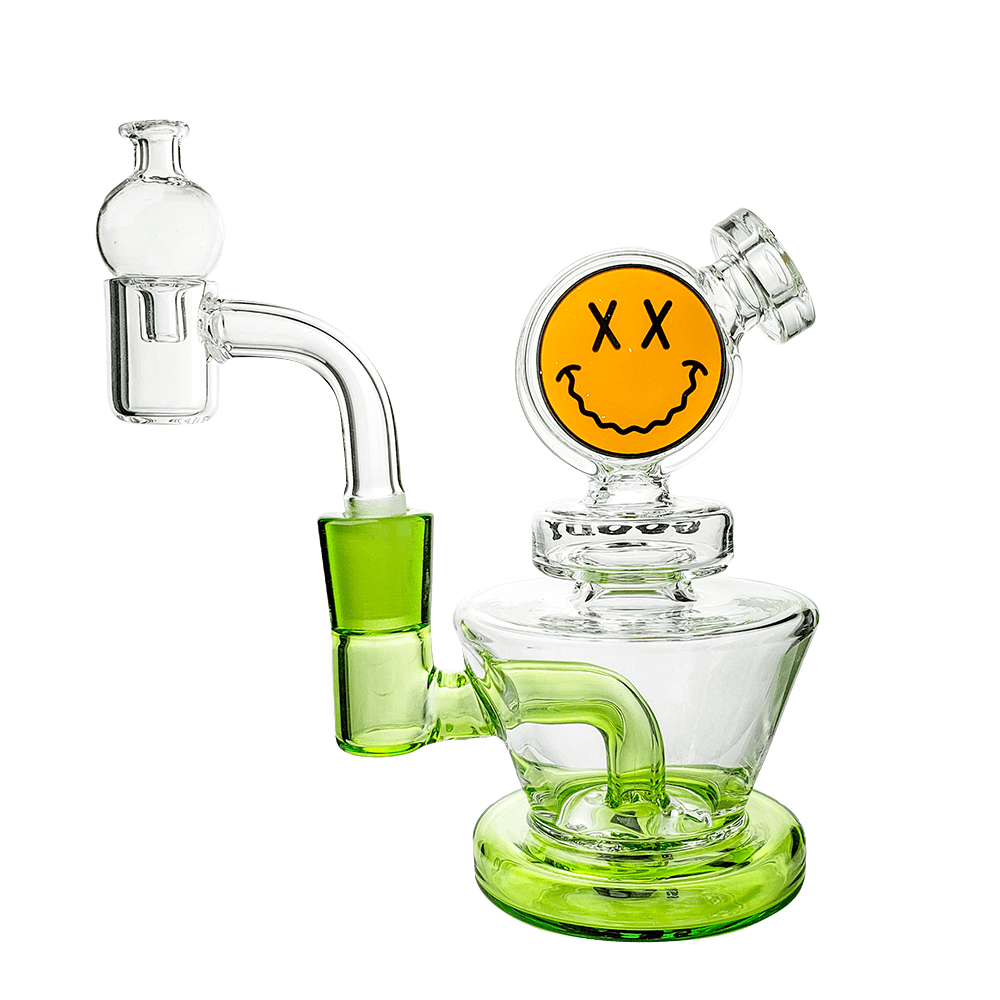 A three-quarter view of the Big Face Mini Rig 4-Piece Kit, a clear glass rig with a unique face-shaped design and visible joint.