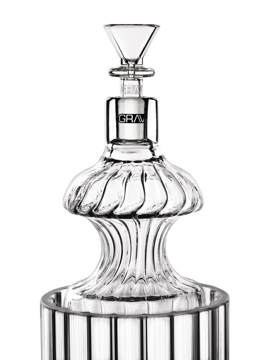Front view of the Monarch Gravity Bong, a clear glass water pipe with a unique ribbed base and cylindrical neck.