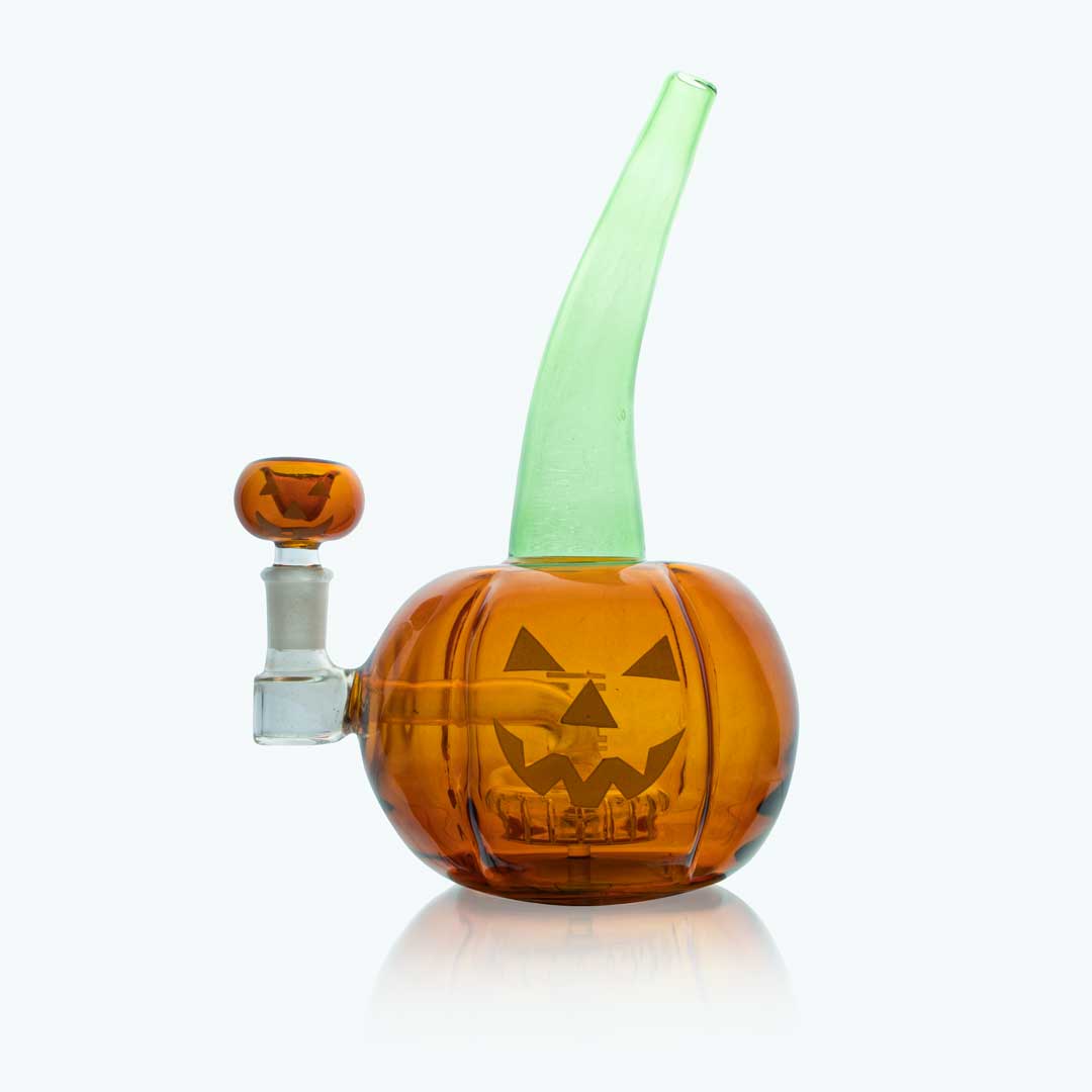 Front view of the Hemper Jack-the-Ripper XL pumpkin-shaped orange glass piece with a tall green stem, set on a white reflective background