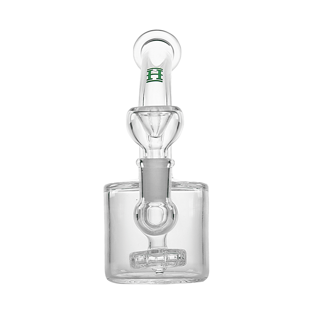 A three-quarter view of the Showerhead Puck Rig, showcasing its compact, clear glass construction and unique showerhead percolator.