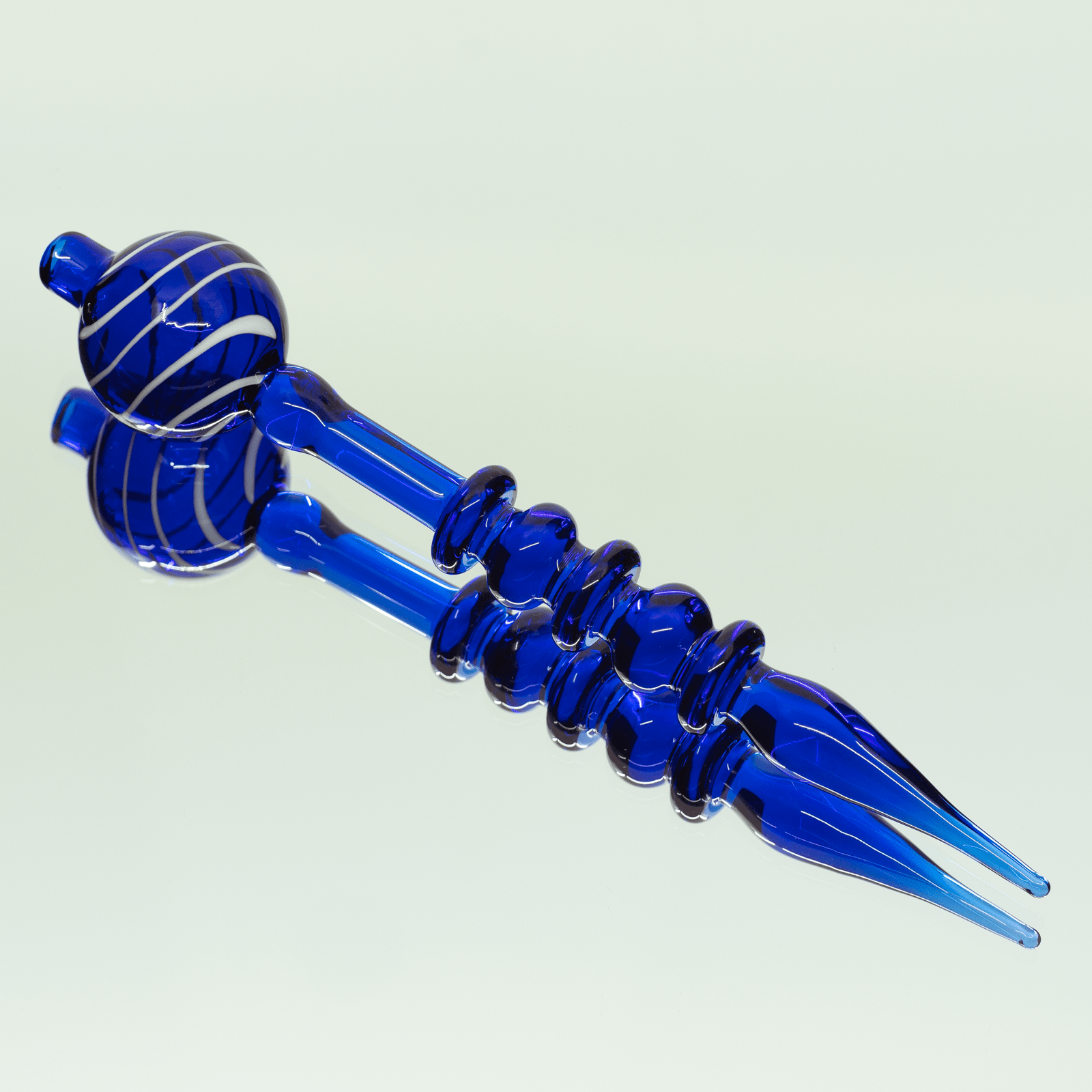 A close-up of the Bubble Head Dab Tool & Carb Cap, showing the blue glass tool angled on a plain white background.