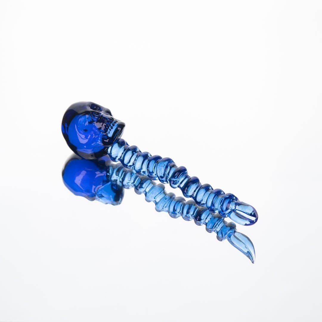 A close-up view of the Skeleton Dab Tool, showing the detailed, curved metal design against a plain white background.