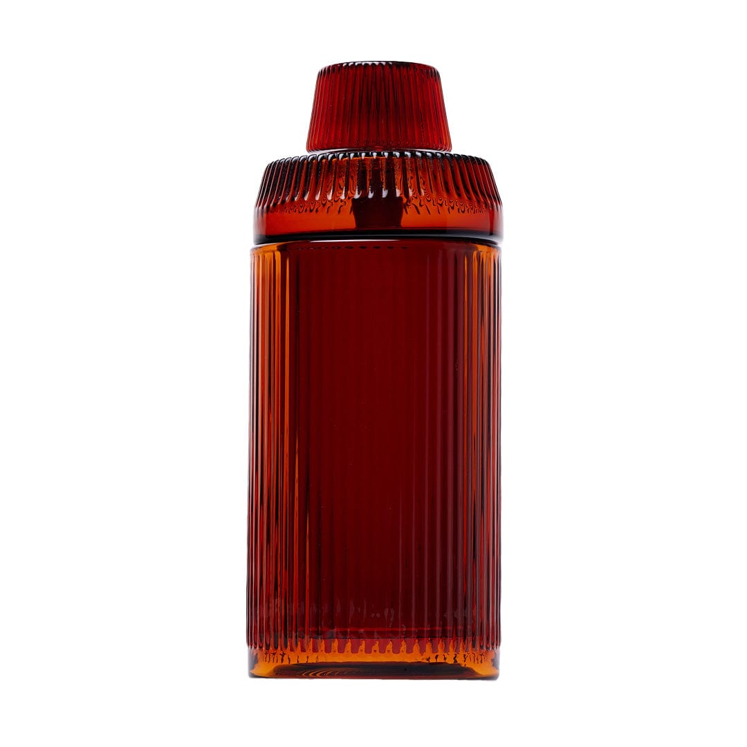 Front-facing studio shot of the Deco Gravity Pipe in Baltic Amber, showing its tall ribbed glass body and matching ridged cap against a white background