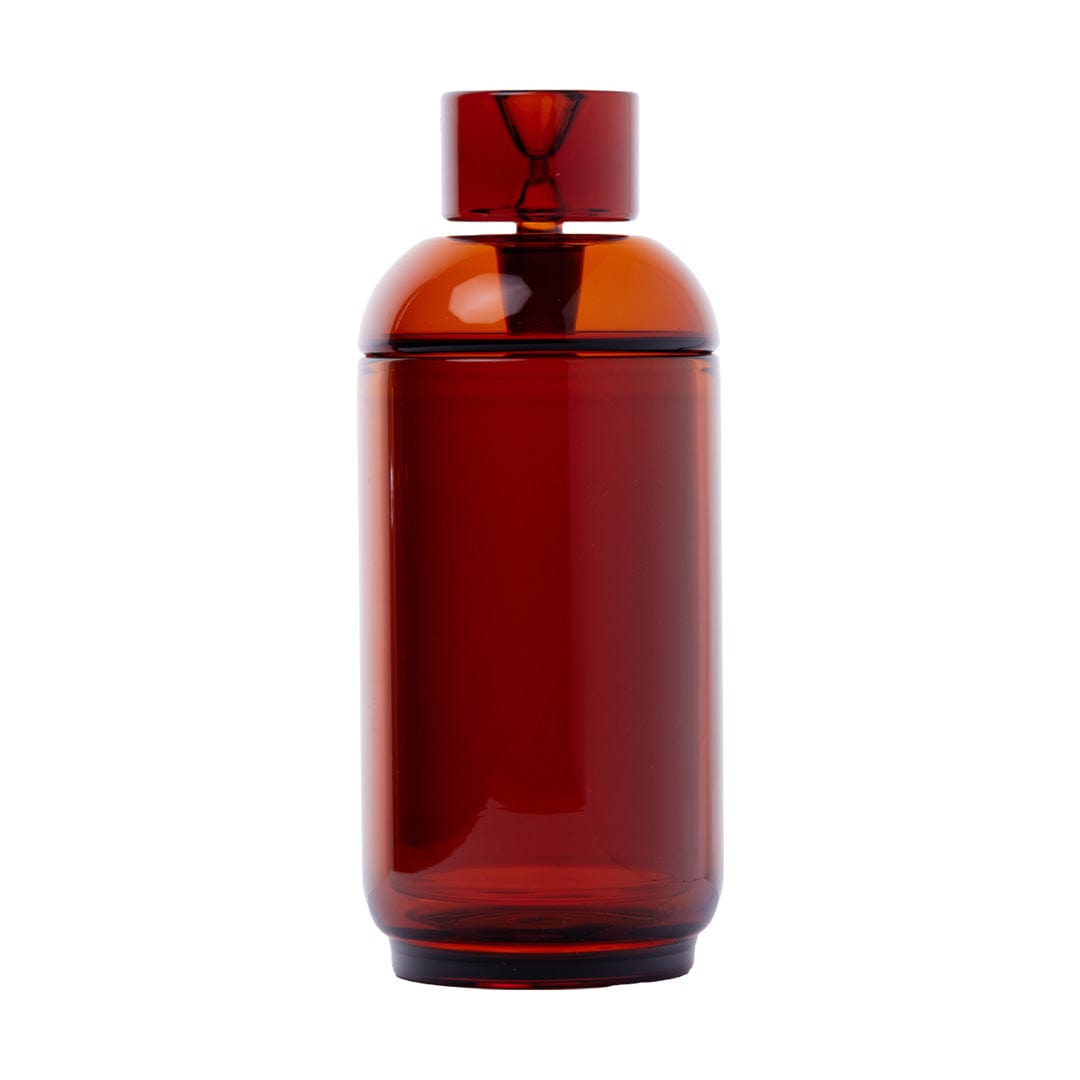 Centered front view of the Vesper Gravity Pipe in Baltic Amber, a glossy cylindrical glass piece with a rounded shoulder and matching cap against a white background