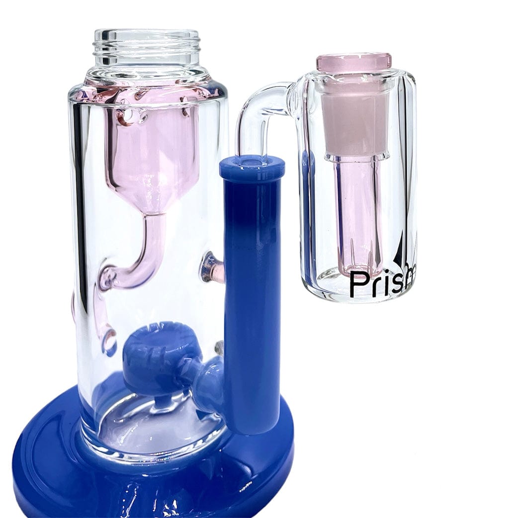 Angled close-up of the Prism Klein Incycler Base Ash Catcher showing clear glass chambers with pink internal percolators and a glossy blueberry-blue handle and base.