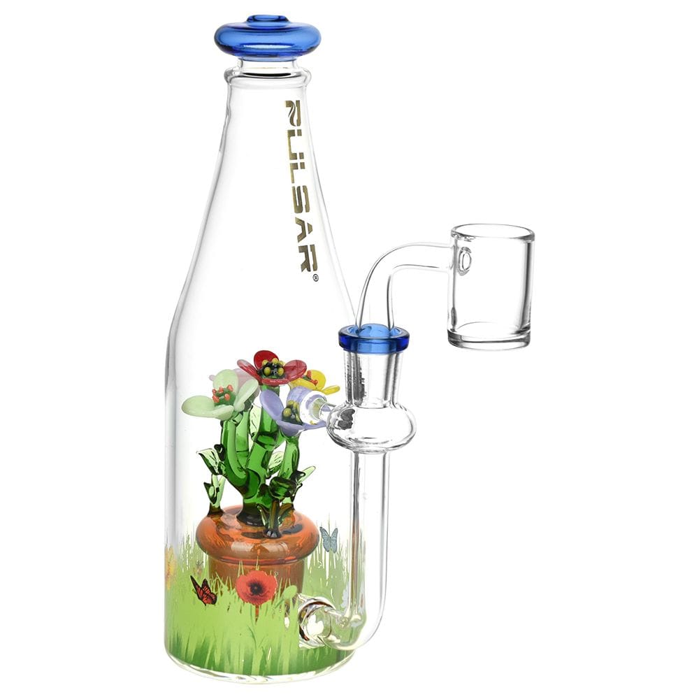 Angled front view of the clear Pulsar Flower Garden Bottle Rig with a blue-rimmed mouthpiece and a colorful glass flower bouquet inside.