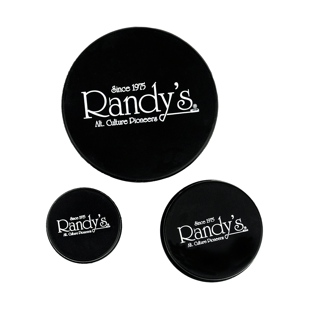 Close-up of Randy's Black Label Cleaning Caps, stacked and displayed against a solid black backdrop.