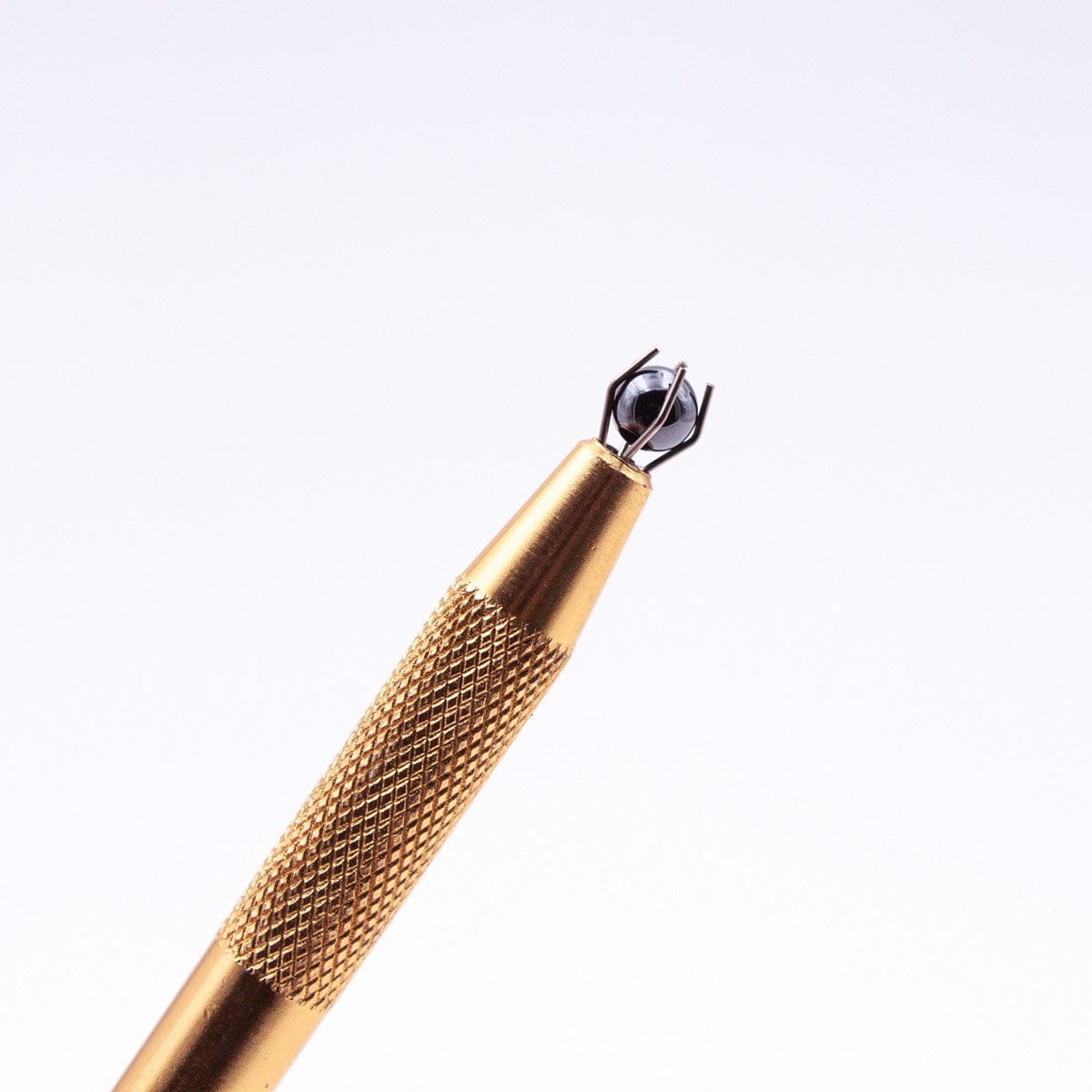 Close-up shot of the Silicon Carbide Terp Pearls, showcasing the textured metallic surface and rounded tip against a dark background.