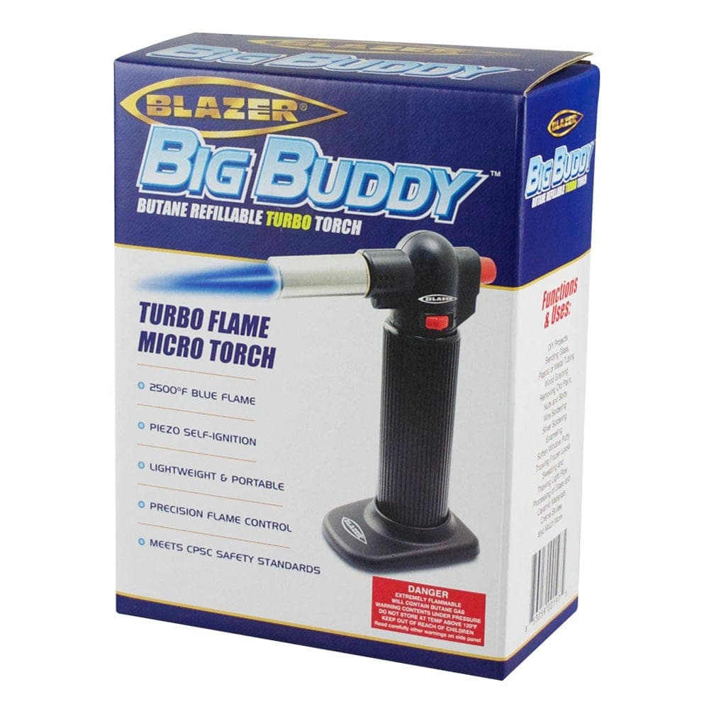 A close-up, angled shot of the Blazer Big Buddy Torch Lighter with a blue flame, highlighting the product's labeled features and packaging.