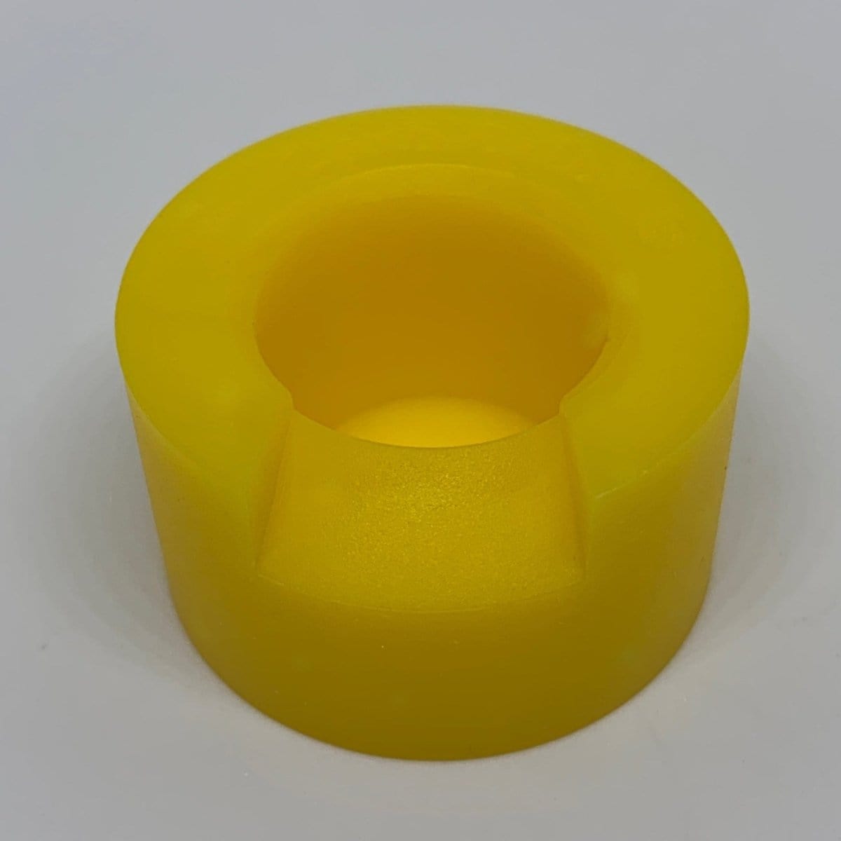 A top-down view of the V2 Carb Crib ® with a smooth, rounded shape and a reflective, glossy surface.