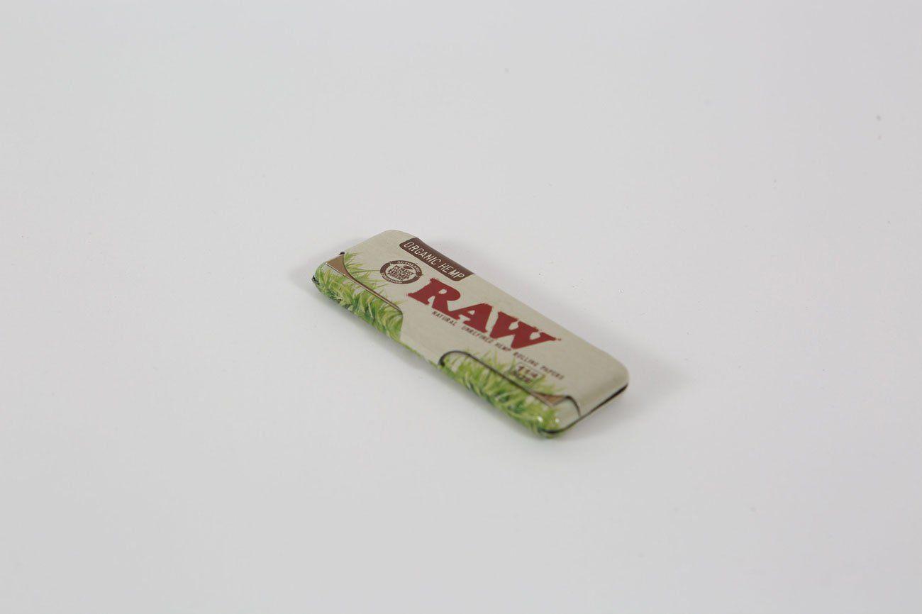 A close-up shows the Raw Paper Tin with a metallic finish, presented against a plain white background.