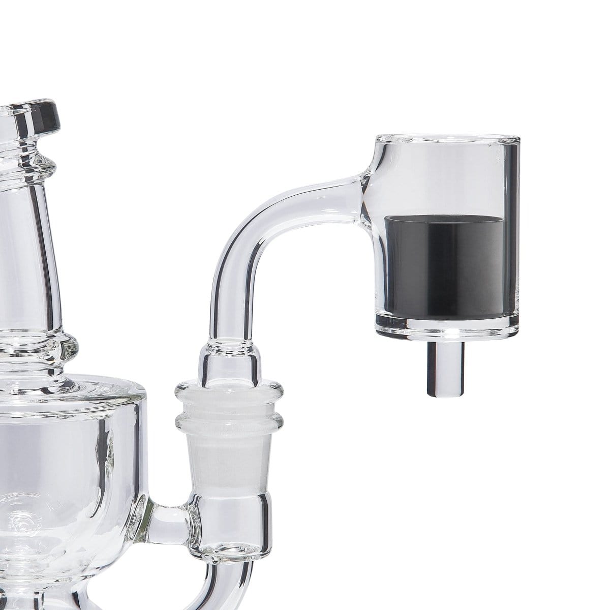 A close-up view of the SIC E-Banger Insert nestled inside a clear glass water pipe, showcasing its reflective surface.