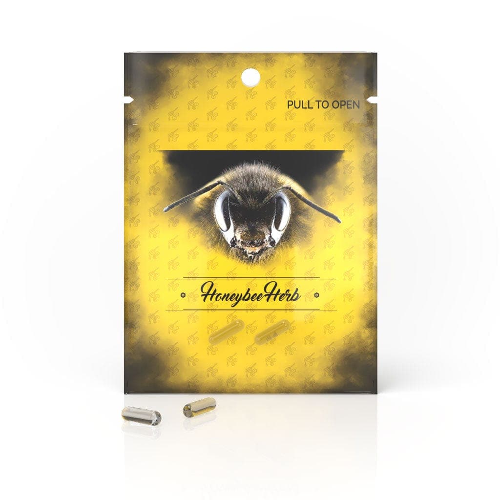 A close-up of Honeybee Herb Honey Capsules, arranged on a reflective surface with a blurred background.
