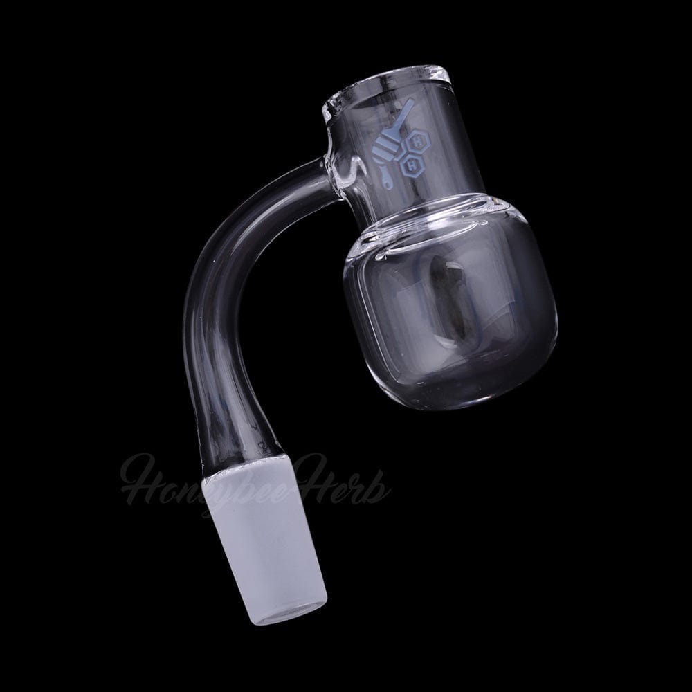 Angled close-up of a clear Honey Kettle Quartz Banger - 90° Degree | Yl showing its 90-degree joint and rounded bucket against a black background
