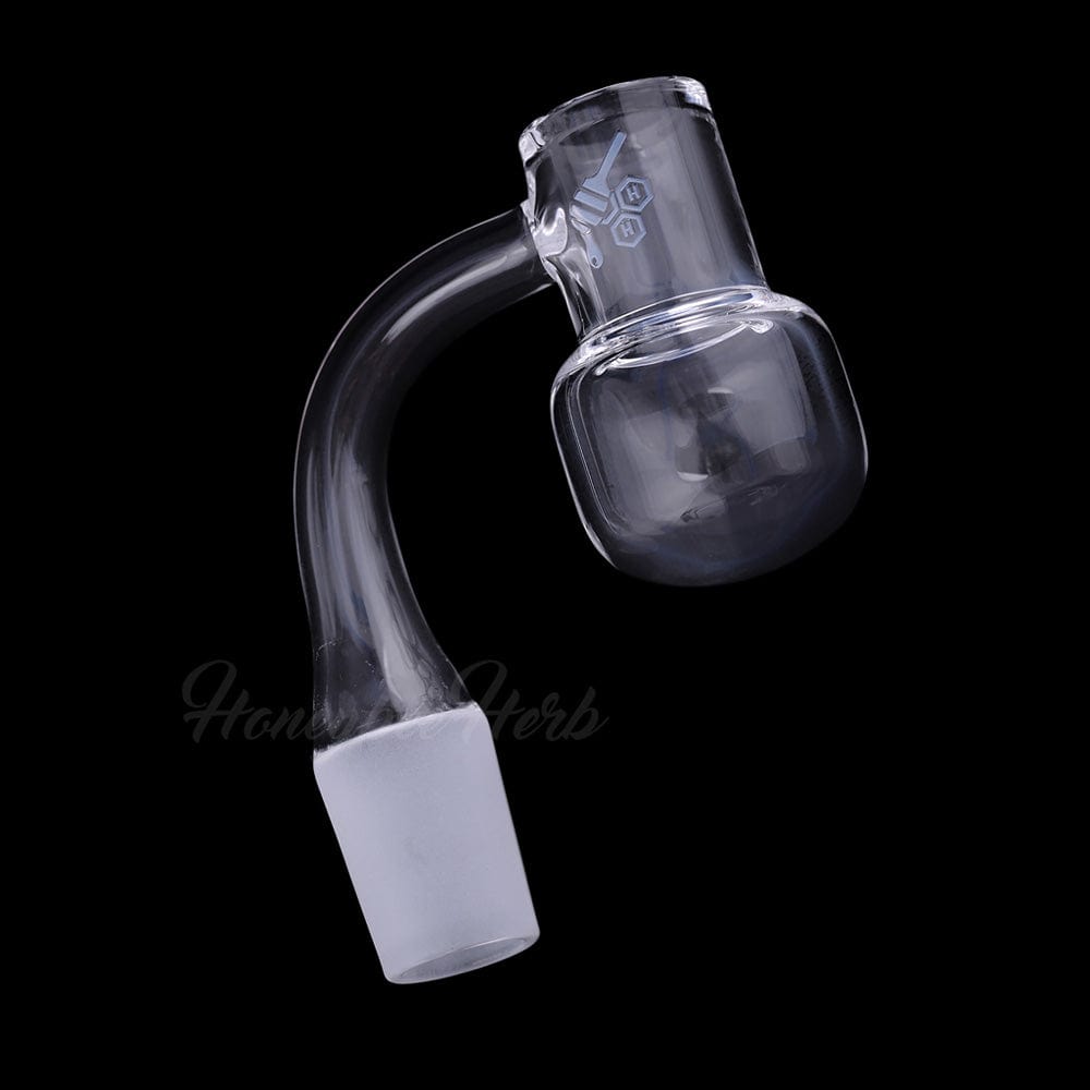 Angled close-up of the Honey Kettle Quartz Banger - 90Â° Degree | Yl showing its curved neck and clear bucket against a black background