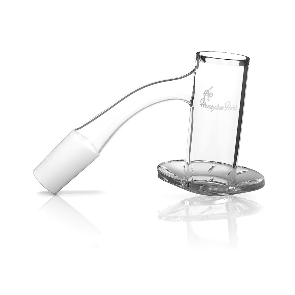 Angled close-up of the Honeybee Herb Beehive Quartz Banger - 45Â° Degree | Bl showing its clear glass bucket and curved 45° neck resting on a reflective white surface