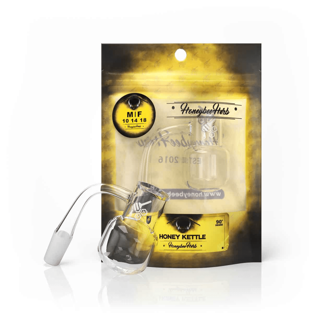 Angled front view of the Honey Kettle Quartz Banger - 90Â° Degree | Yl sitting in front of its yellow and black branded pouch, lit from above.