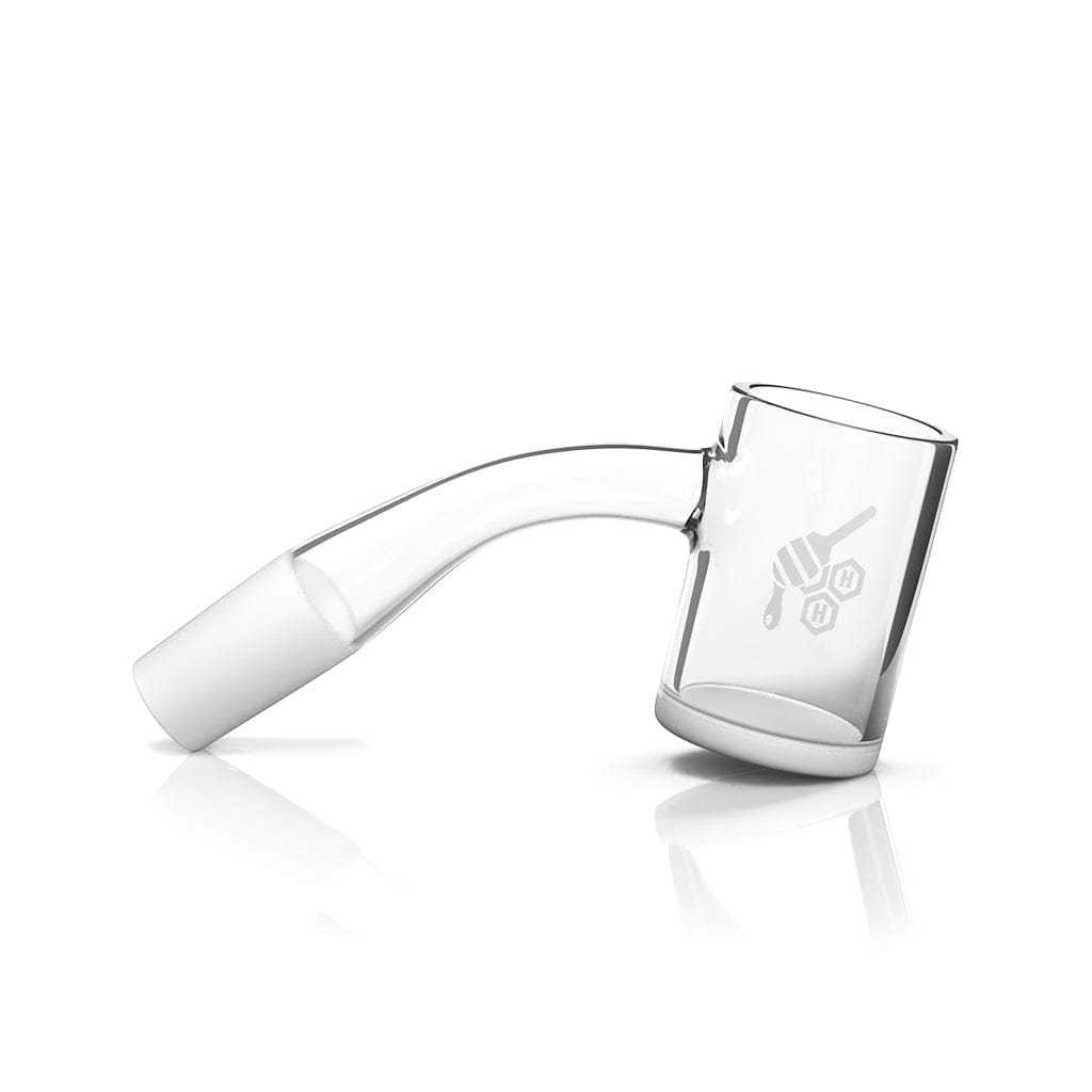 A 45-degree angled view of the HONEY & MILK QUARTZ BANGER, displaying its clear glass construction and simple cylindrical shape.