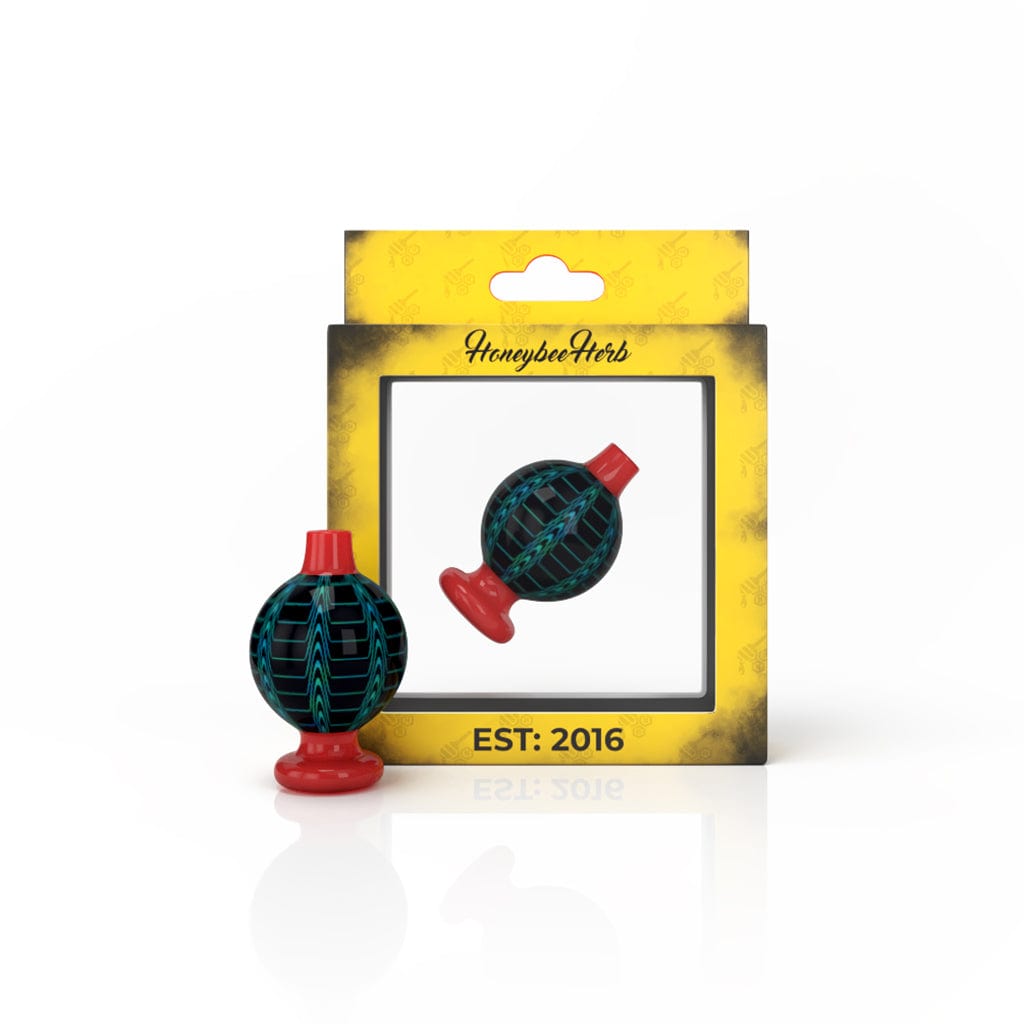 A close-up shot of the DREAM BUBBLE CARB CAP, showcasing its colorful, bubble-like design against a dark background.