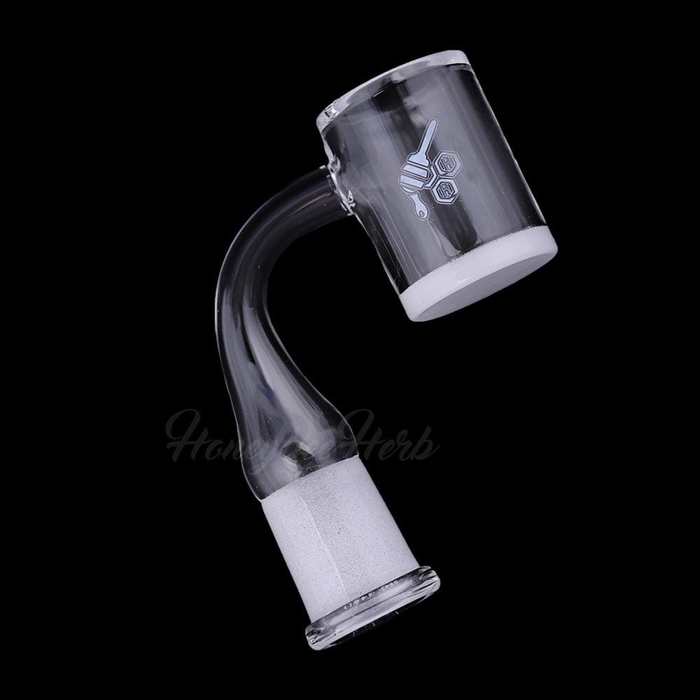 A studio shot of the HONEY & MILK BEVEL QUARTZ BANGER - 90° DEGREE  YL, showcasing its angled quartz construction against a dark backdrop.