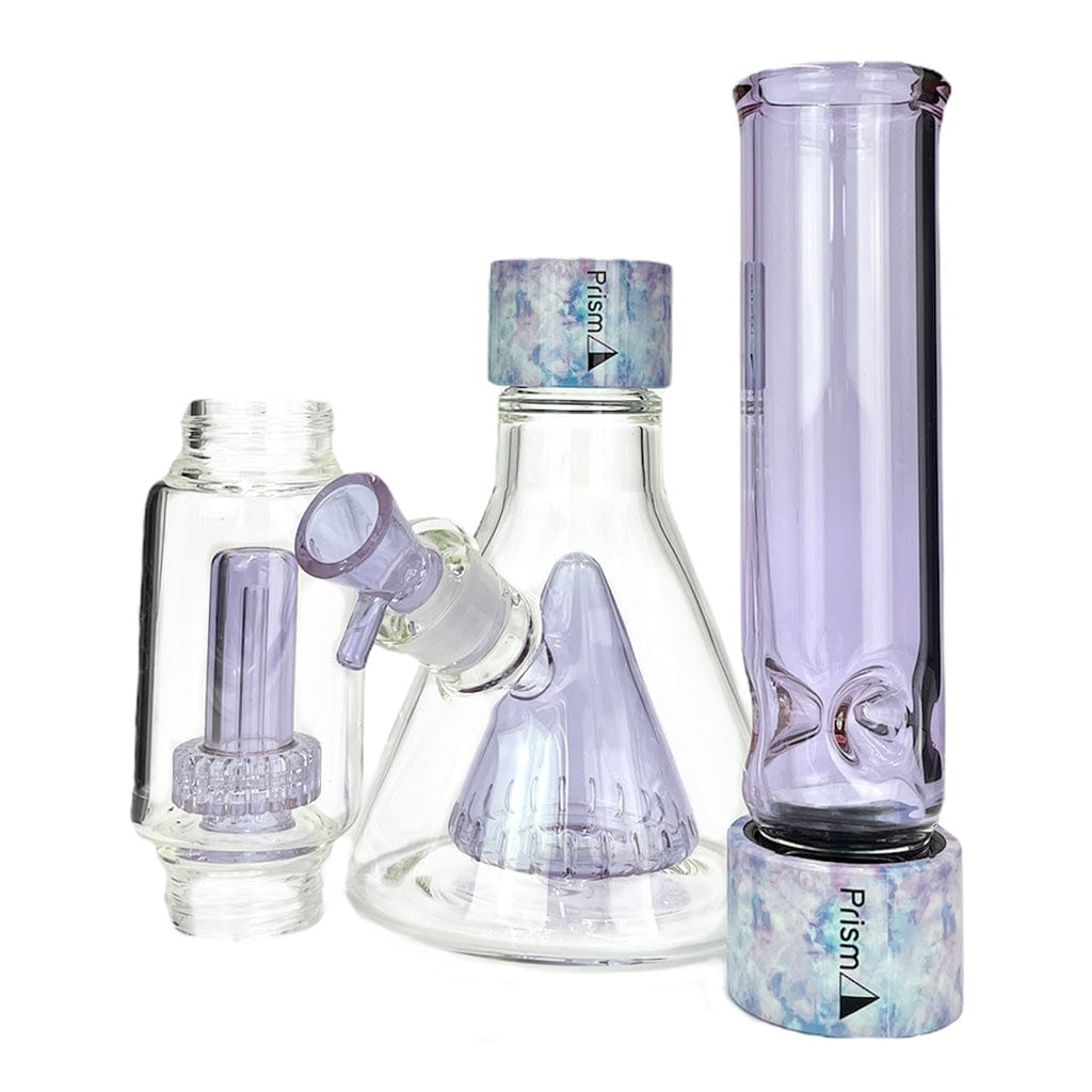 Front three-quarter view of the Prism Percolated Beaker Double Stack showing its clear glass beaker body with lilac-colored percolators and matching lilac mouthpiece set against a white background.
